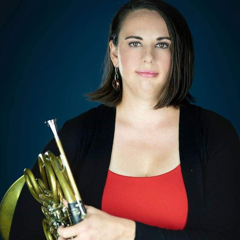Woman holding French Horn